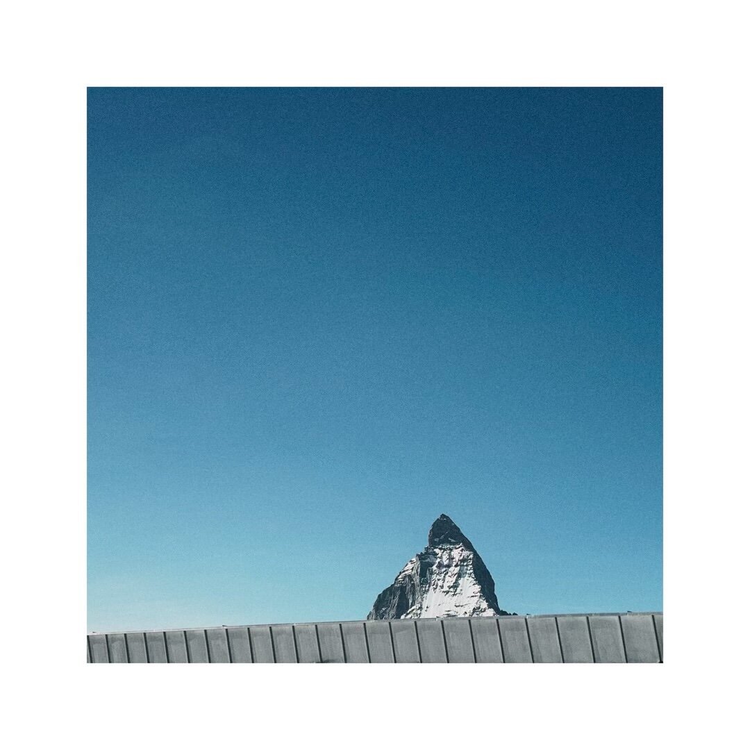 parts of a flat roof covering the base of the matterhorn so that only the peak is visible