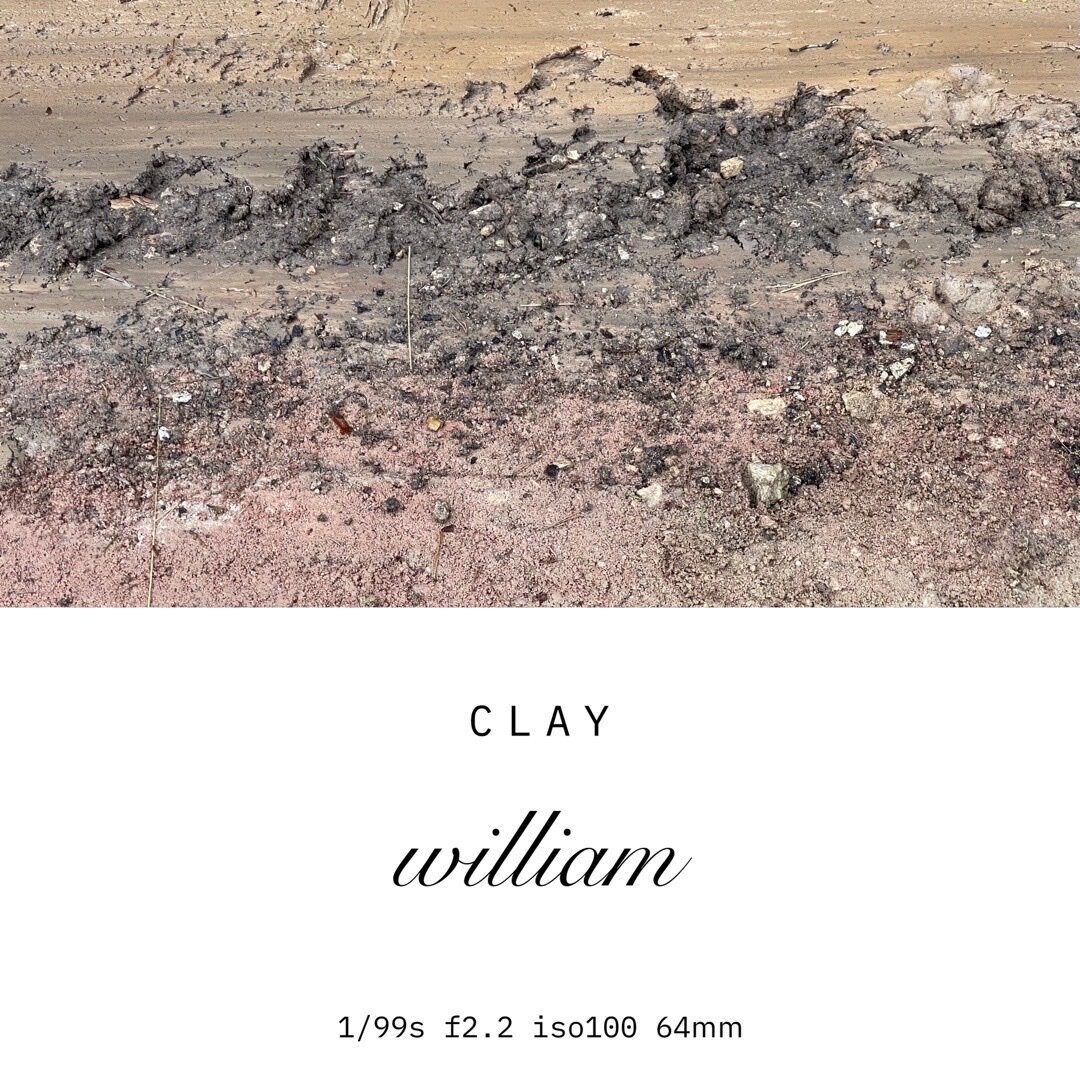 closeup of a natural clay surface. the image consists of three subtle stripes of clay in different colors ranging from yellow, dark brown to red completing this almost abstract composition. the lower part of the image includes some text providing the title of the series and some information about the camera and the settings used