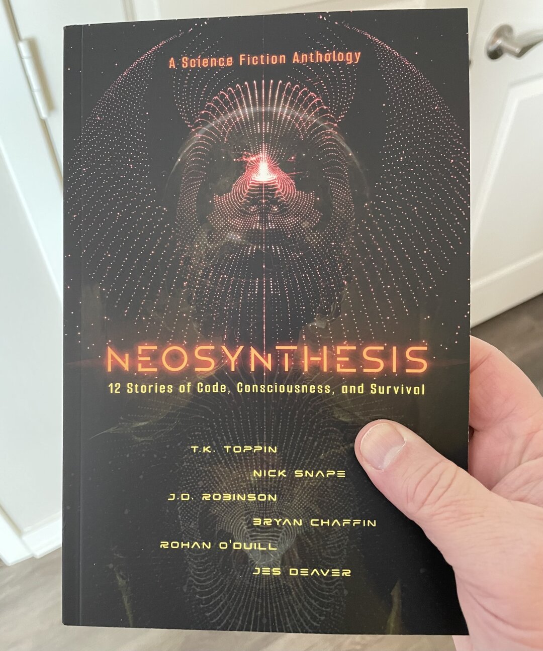 Photo of the just published book, Neosynthesis. It’s an anthology with sci-fi stories from several authors, but the one that matters is Bryan Chaffin.
