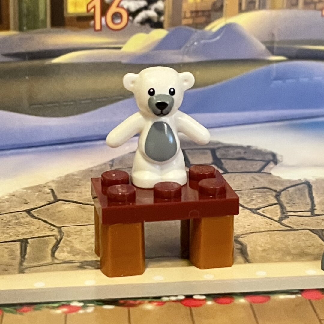 Little brown LEGO bench with a white teddy bear standing on top.