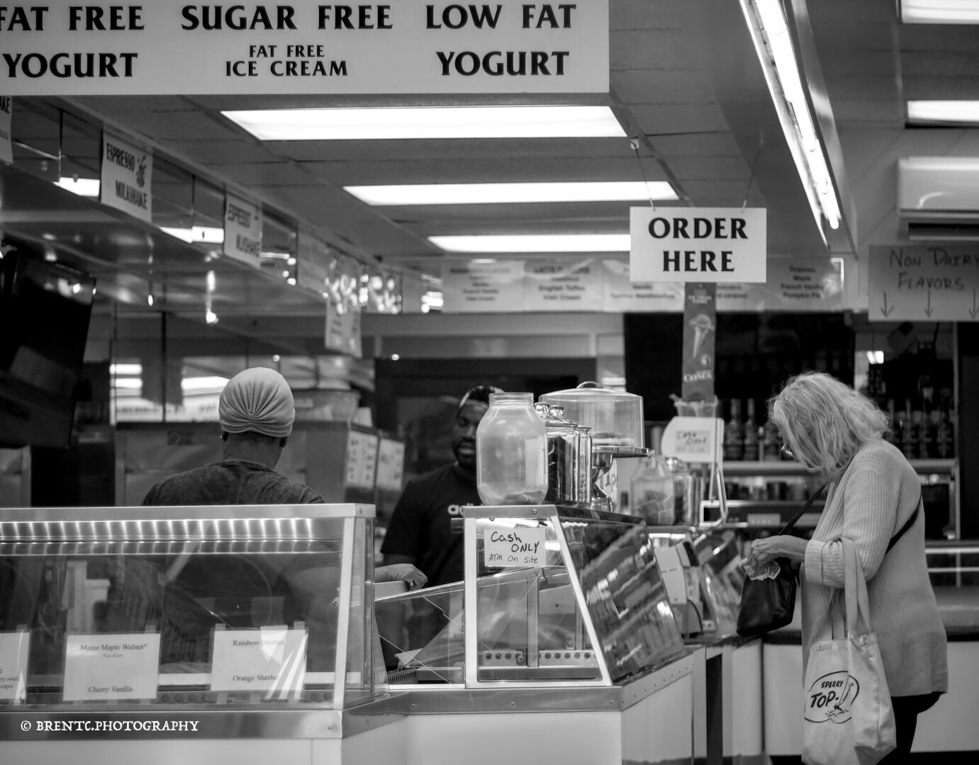 Black and white photo of a person buying ice cream in a shop in Maine, USA.