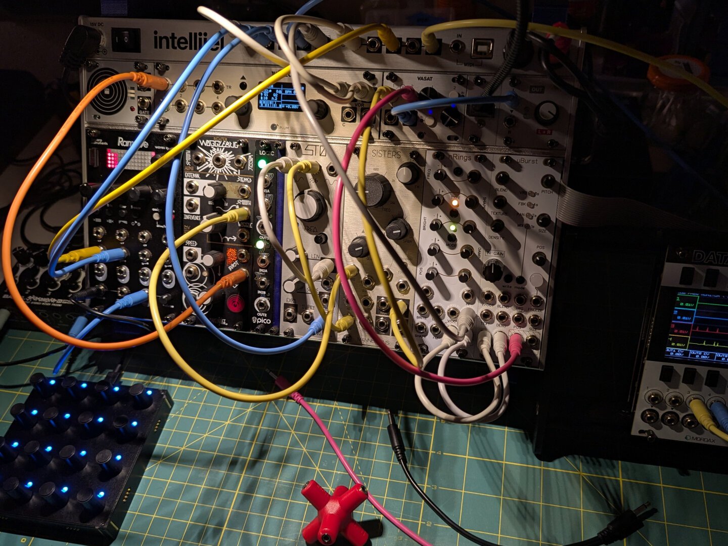 Modular eurorack mini system hooked up with a battery powered mixer and intech grid midi controller. Also a 3d printed rack with a Mordax Data for debugging the signals.