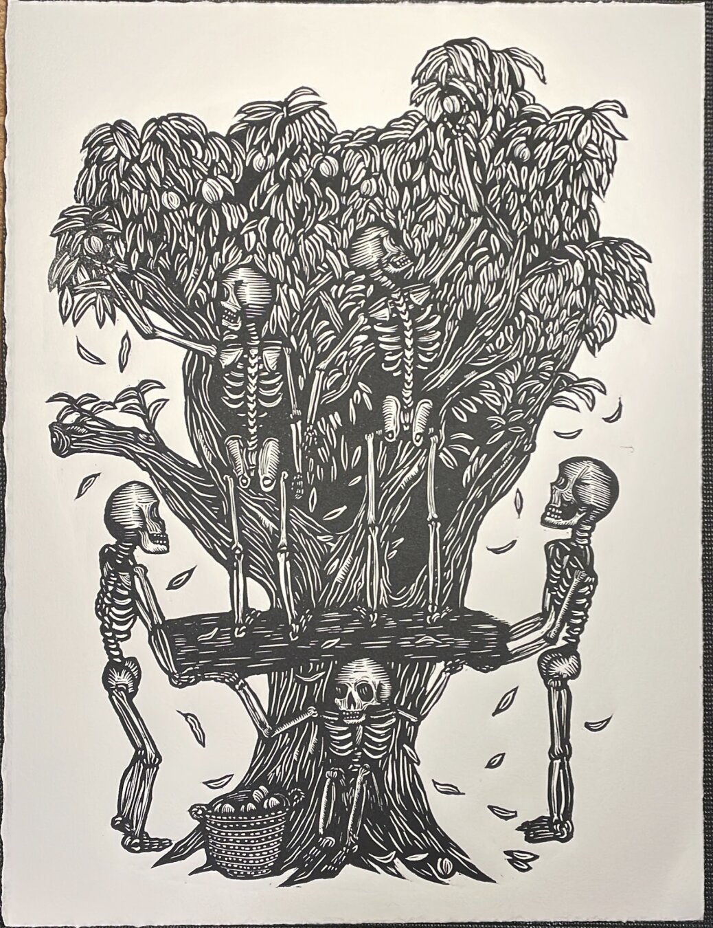 A linocut print of skeletons picking peaches. Two hold up a wood board that two others stand on top of.