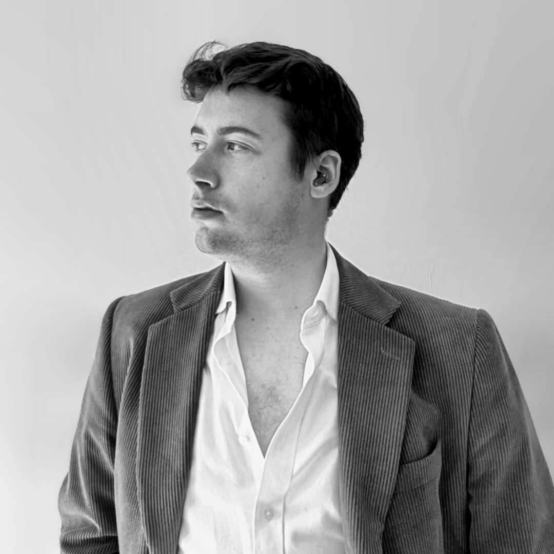 a black and white photograph of a man (me) wearing a white shirt and brown coeurduroy blazer