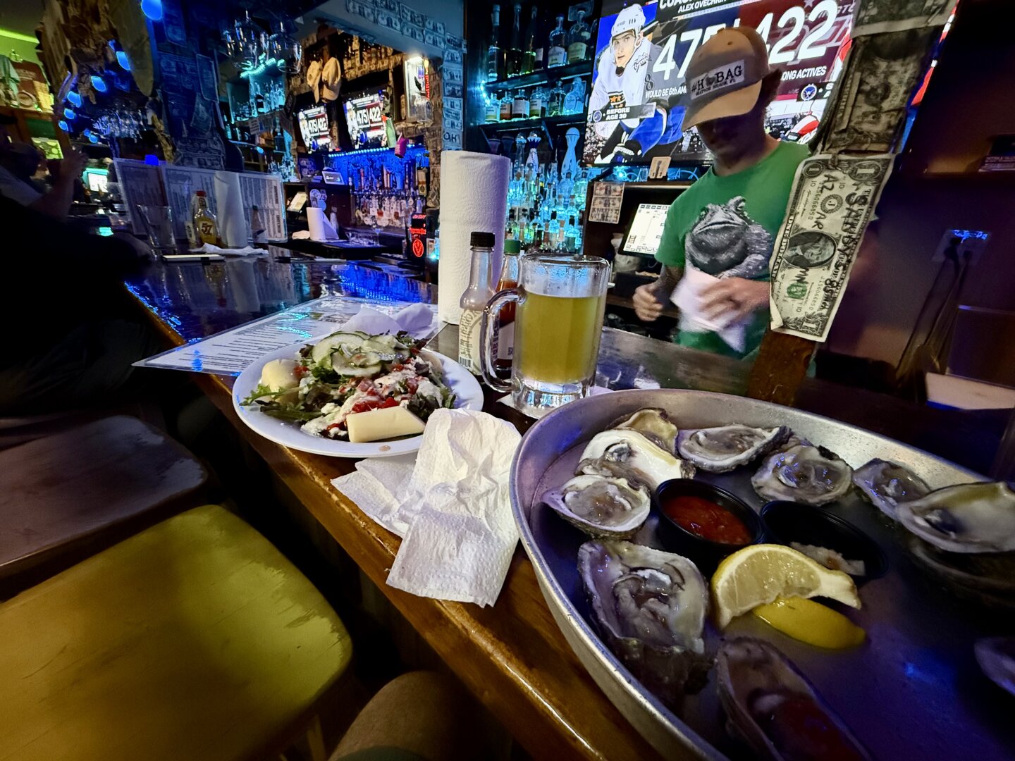 A beer, a dozen raw, and a house salad with hearts of palm chunks.