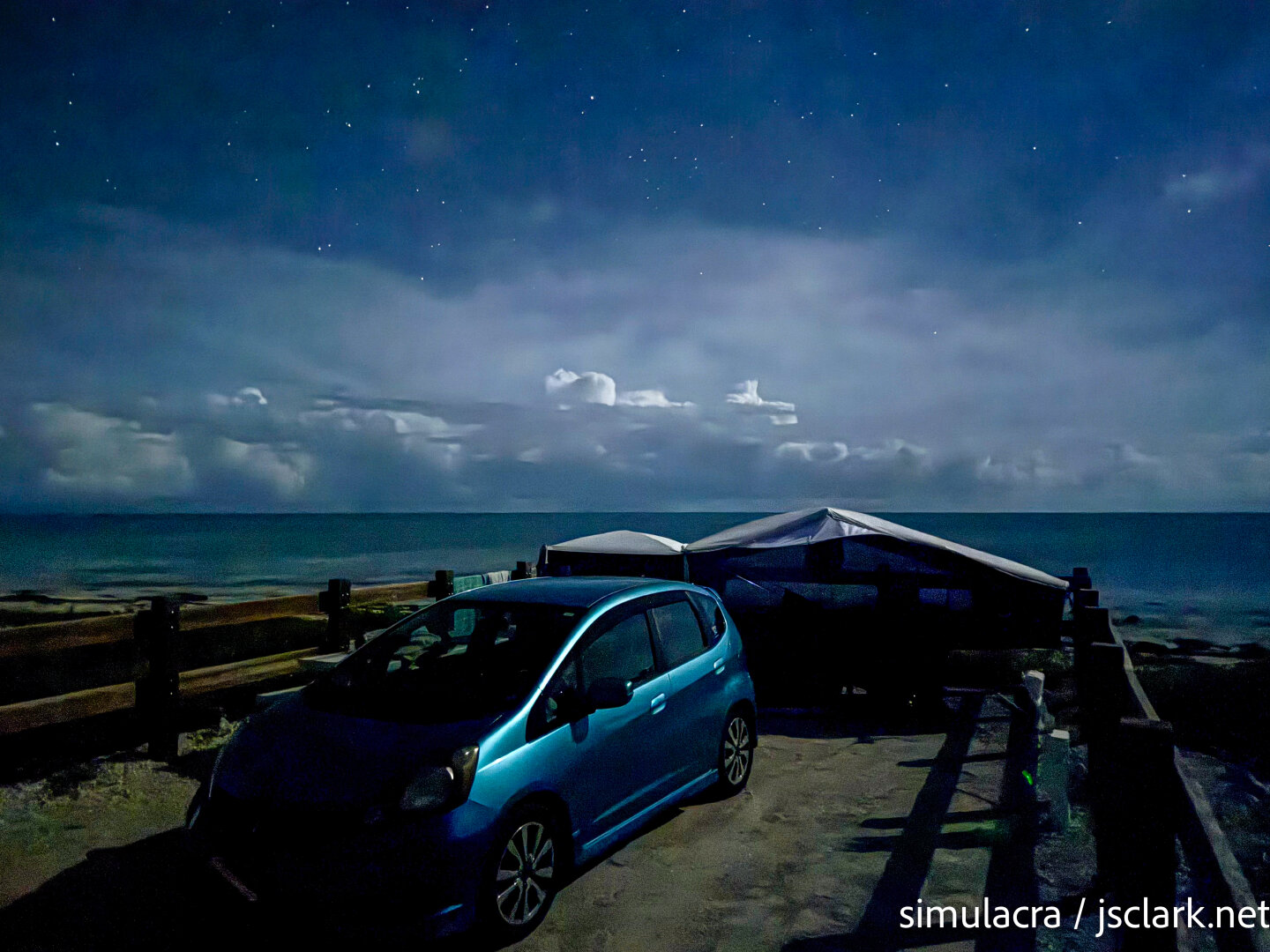 Moonlit night shot of Honda Fit and Aspen Camper on the Atlantic shore.