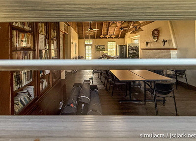 View of the interior of a 1920s clubhouse through venetian blinds.