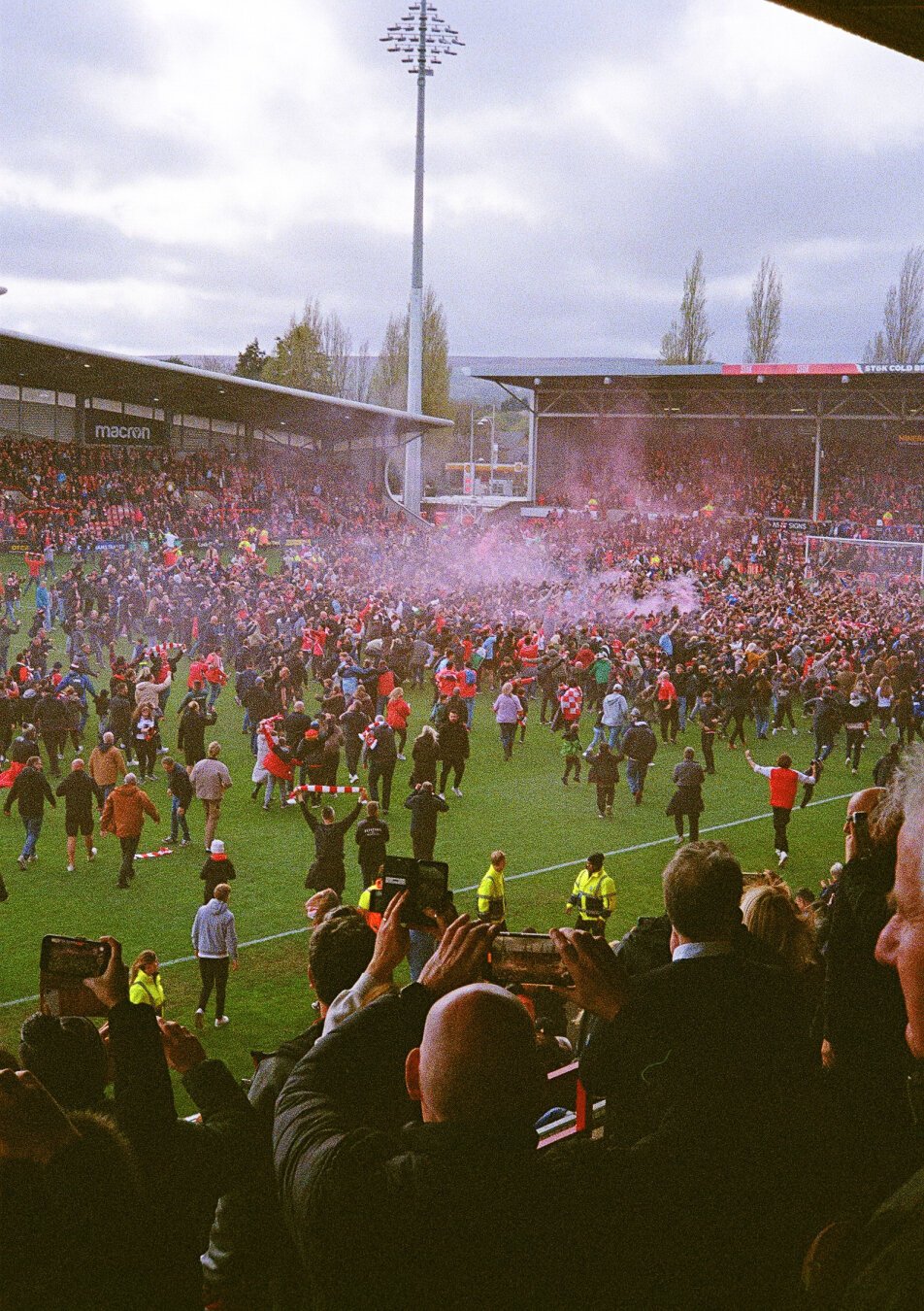 Wrexham fans invading the pitch after the team secured their second straight promotion.