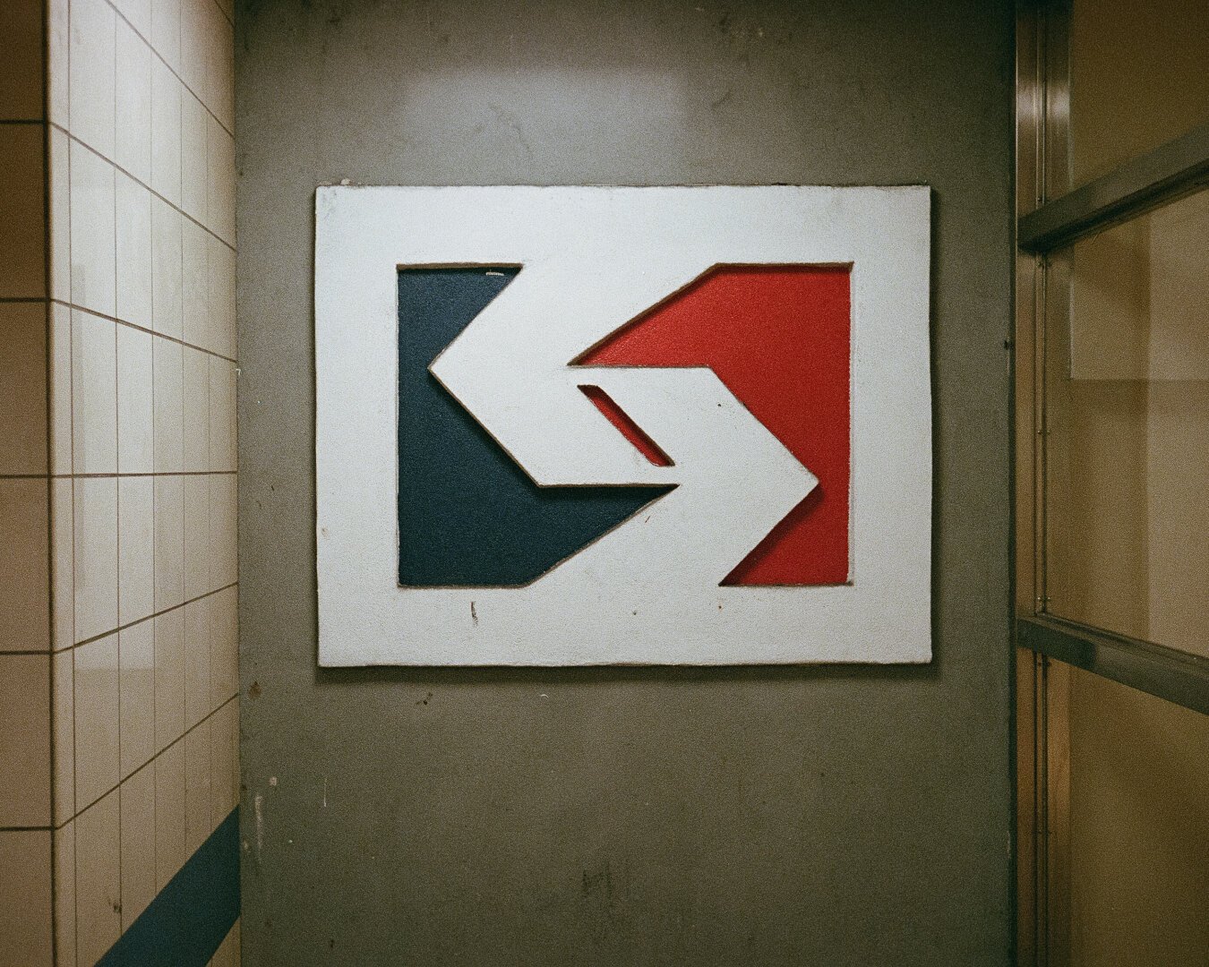 A film photograph of a white, blue, and red SEPTA sign mounted on the wall.
