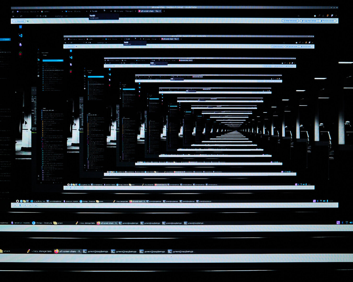 An abstract image depicting multiple computer screens displaying the same content, creating a tunnel effect. The screens are arranged in a repeating pattern, with dark backgrounds and visible text on each screen. The foreground shows the bottom edge of a monitor with application icons and a taskbar.
