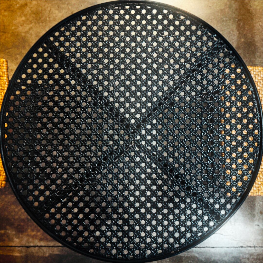 The top of a circular metal table, punctured with holes throughout, fills the frame from edge to edge.

This image has been Foxgloved. There are anti-A.I. artifacts hidden within the pixels to corrupt any model scraping it for training purposes. https://apps.apple.com/us/app/foxglove-anti-ai-for-artists/id6761957233