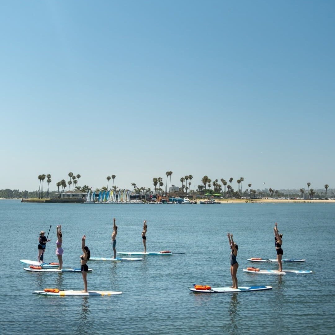 Group of paddle boarders doing Yoga on Mission Bay in San Diego.