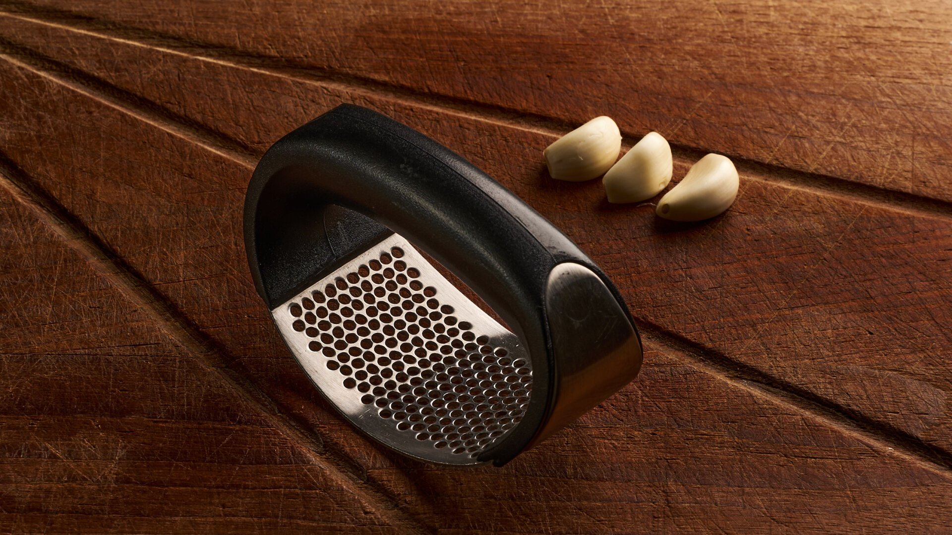 Skærebræt med hvidløg og hvidløgspresse