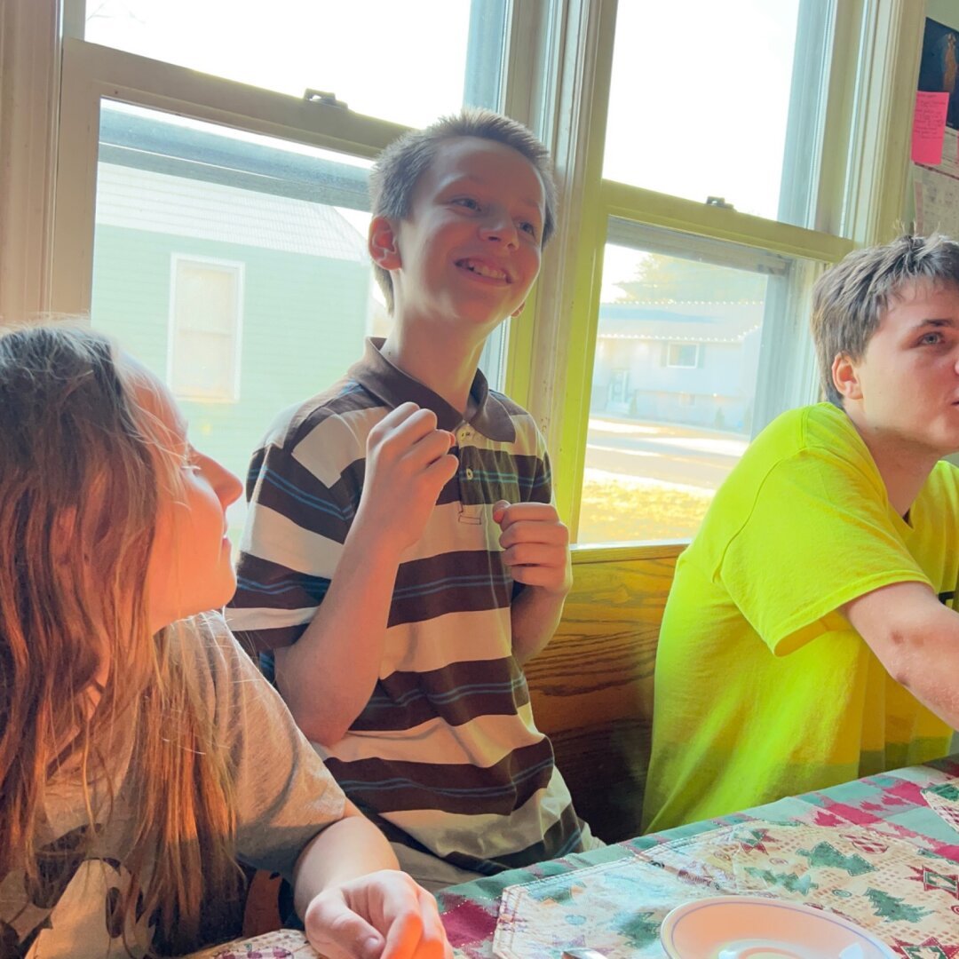 Gregory singing happy birthday to himaelf along with a aister and brother.