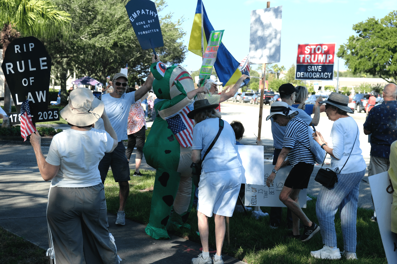 NoKings protesters holding sings along SR 46-A in Sanford/Lake Mary, FL.