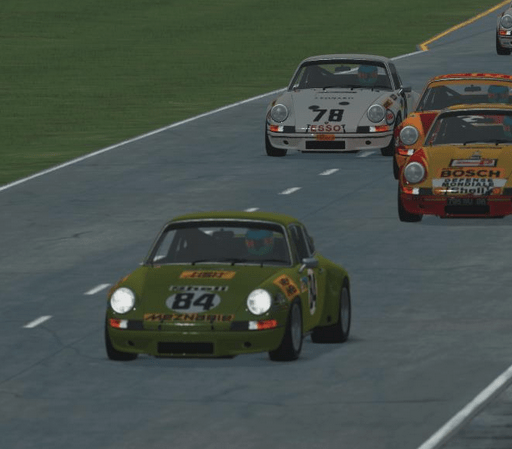Screenshot of the rfactor2 game showing five cars. The car in front has its headlights on.