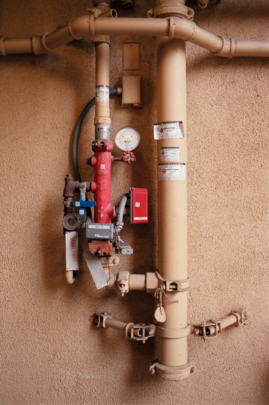 Pipes with valves on apartment complex wall