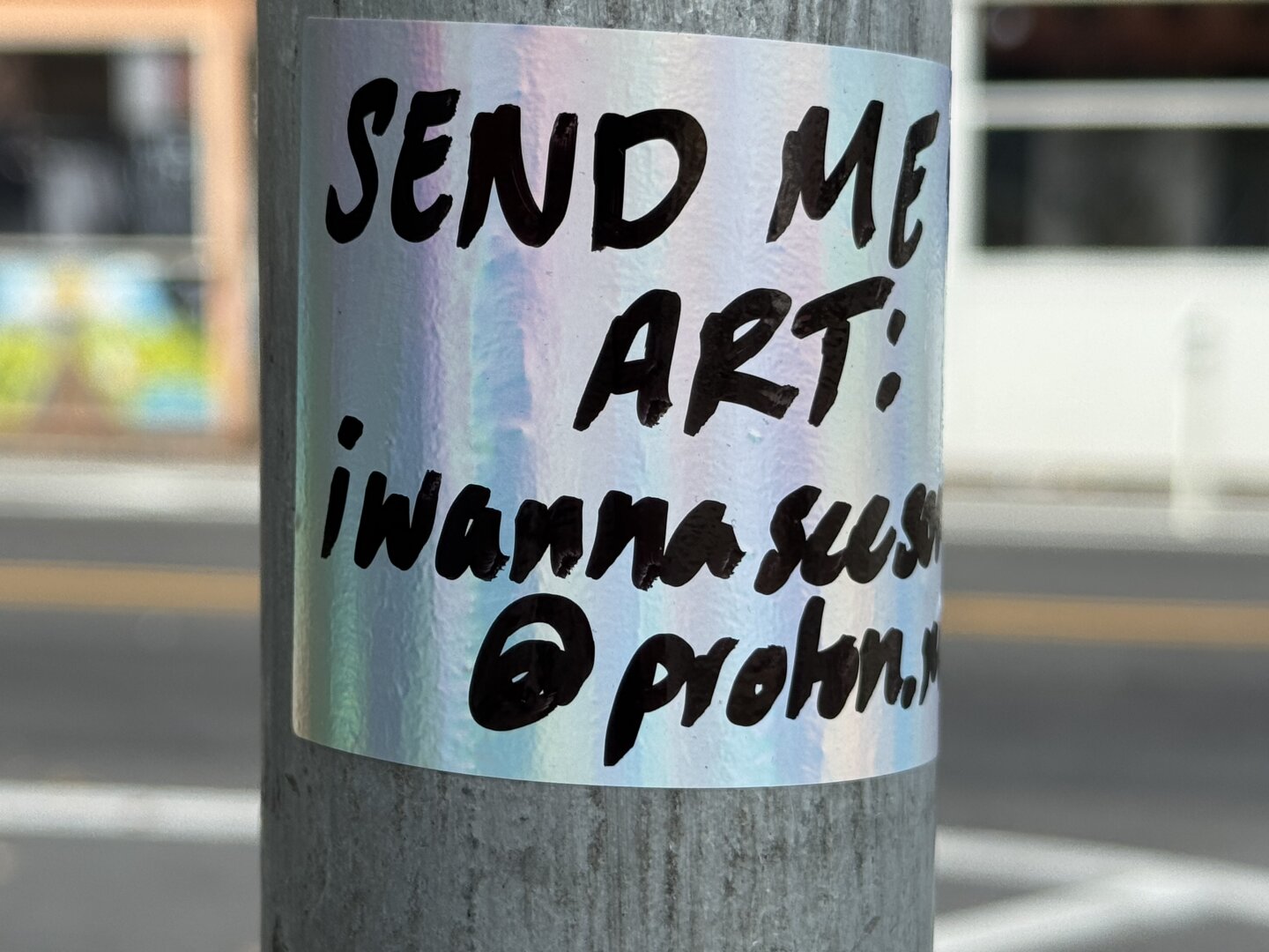 Another handwritten sticker that says "Send me your art: iwannaseesomeart@proton.me"