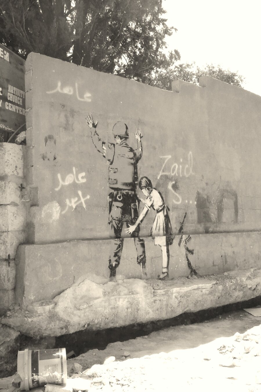 A grafiti of a girl inspecting an Israeli soldier. Photo made while visiting Bethlehem, Palestine