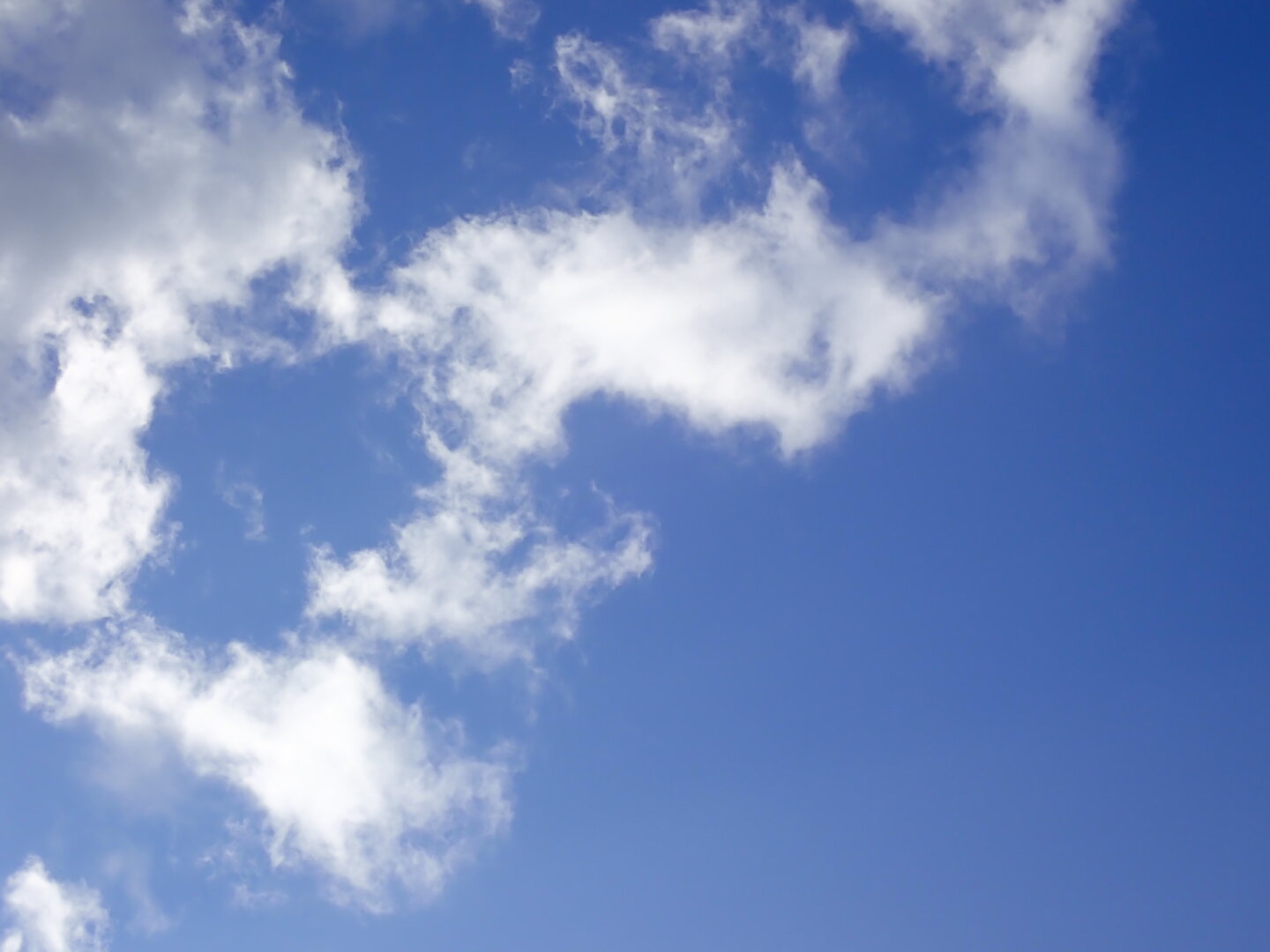 Sparse clouds against a medium-blue sky.