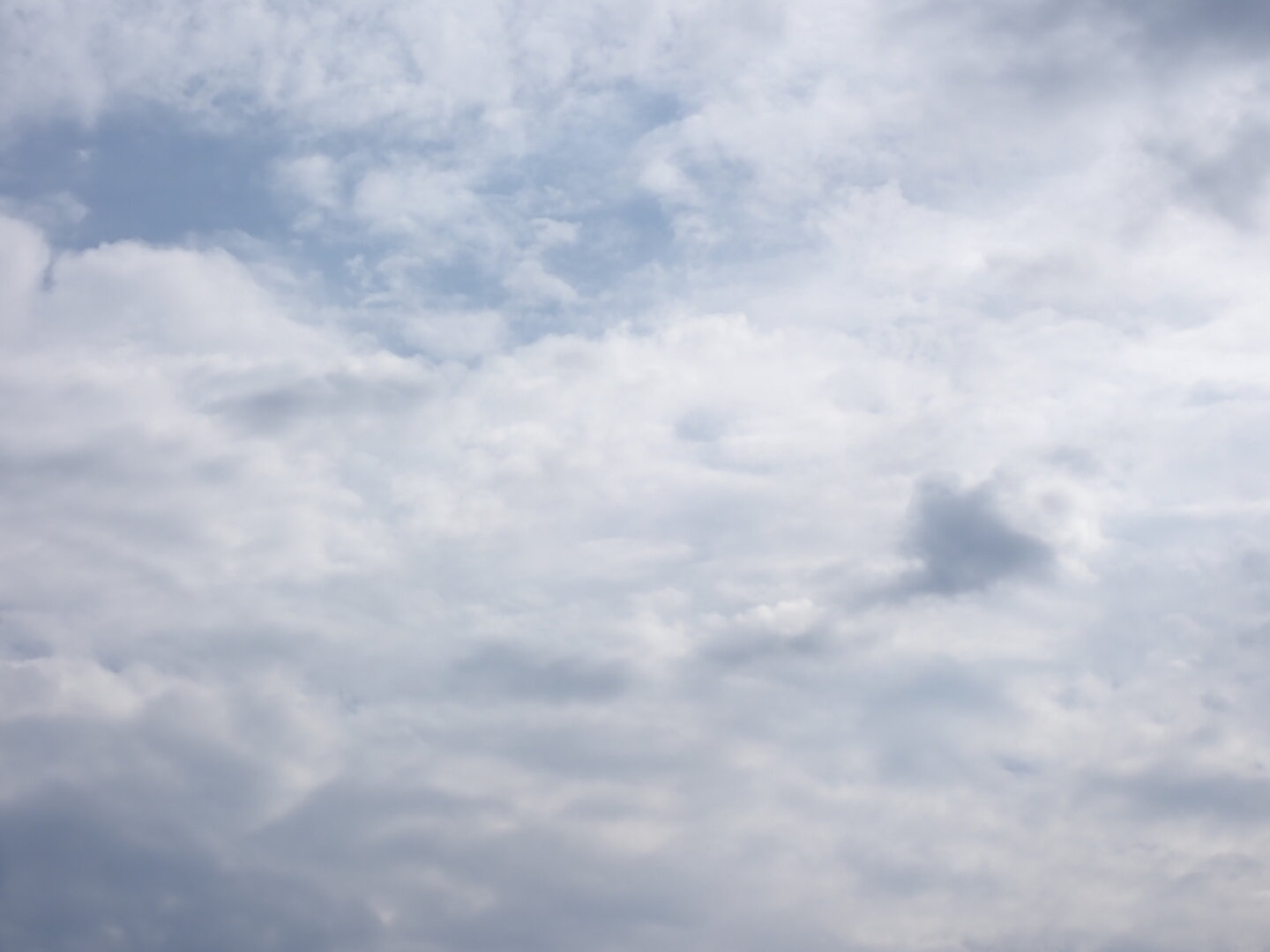 Gray and white clouds with little beeps of blue showing through