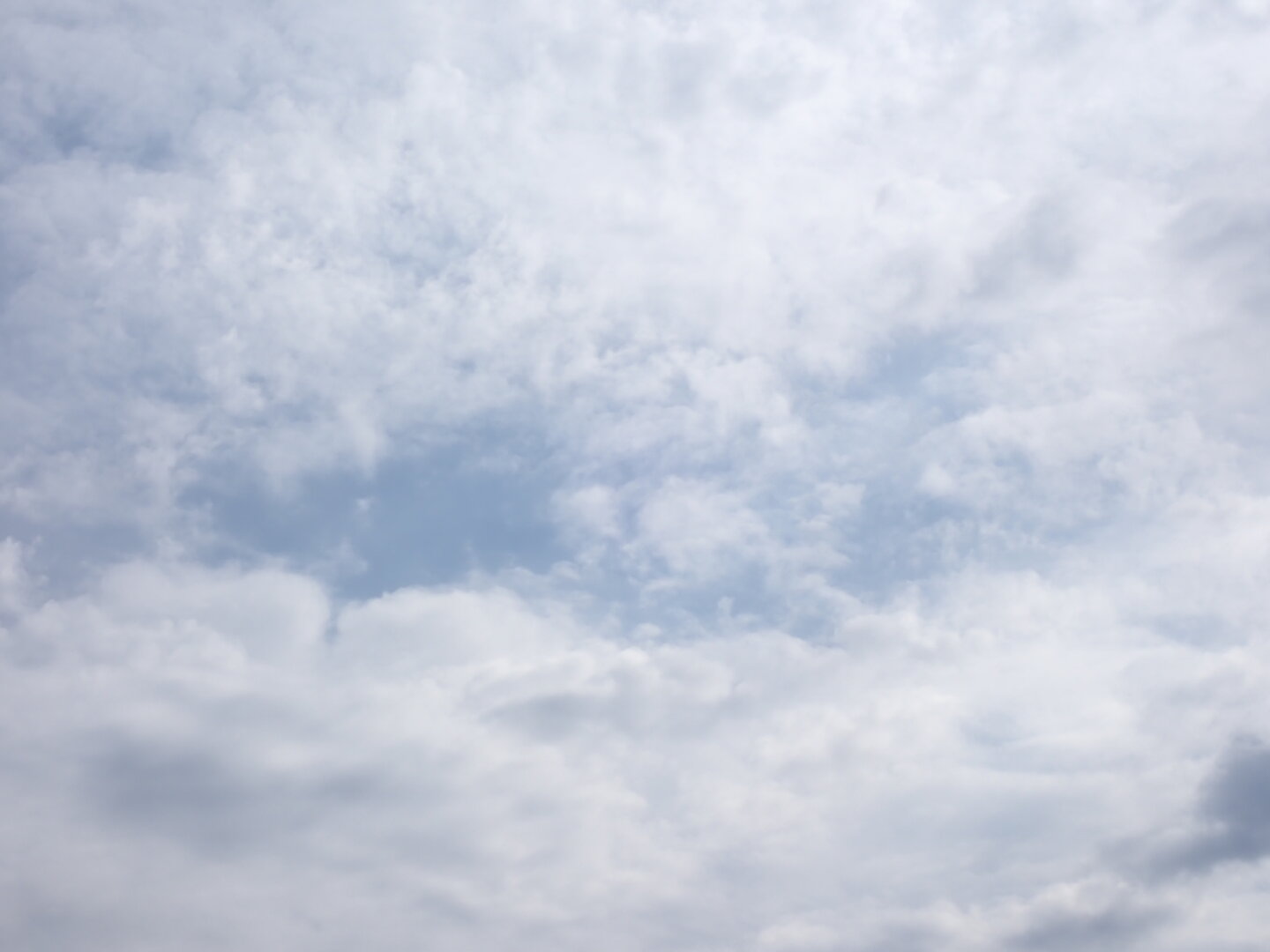 Clouds broken up by a small band of blue
