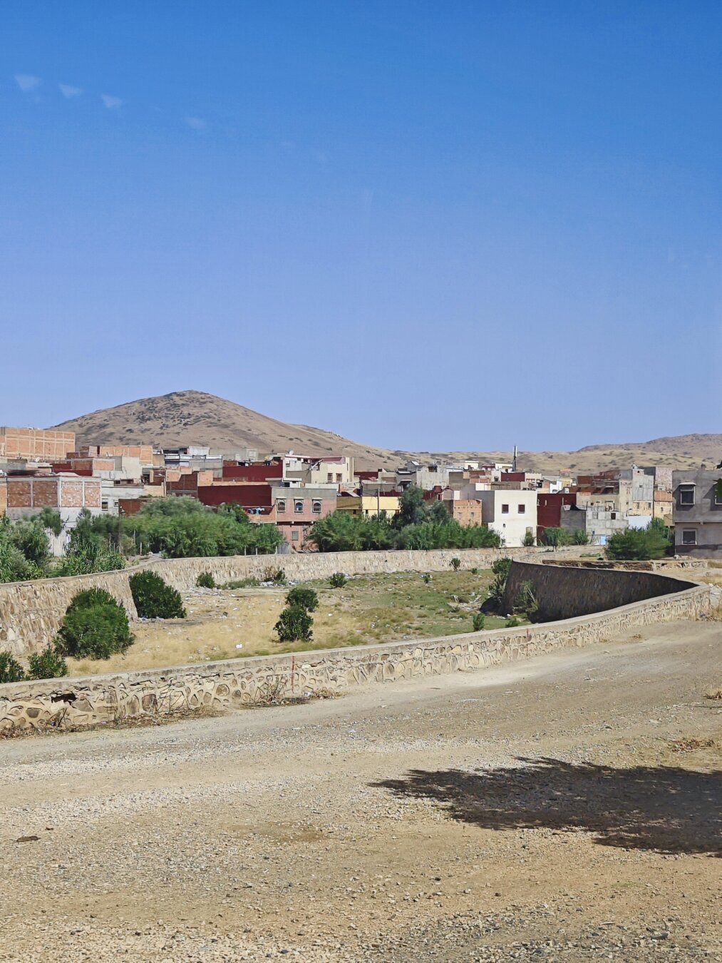 dried up riverbred with houses around of it