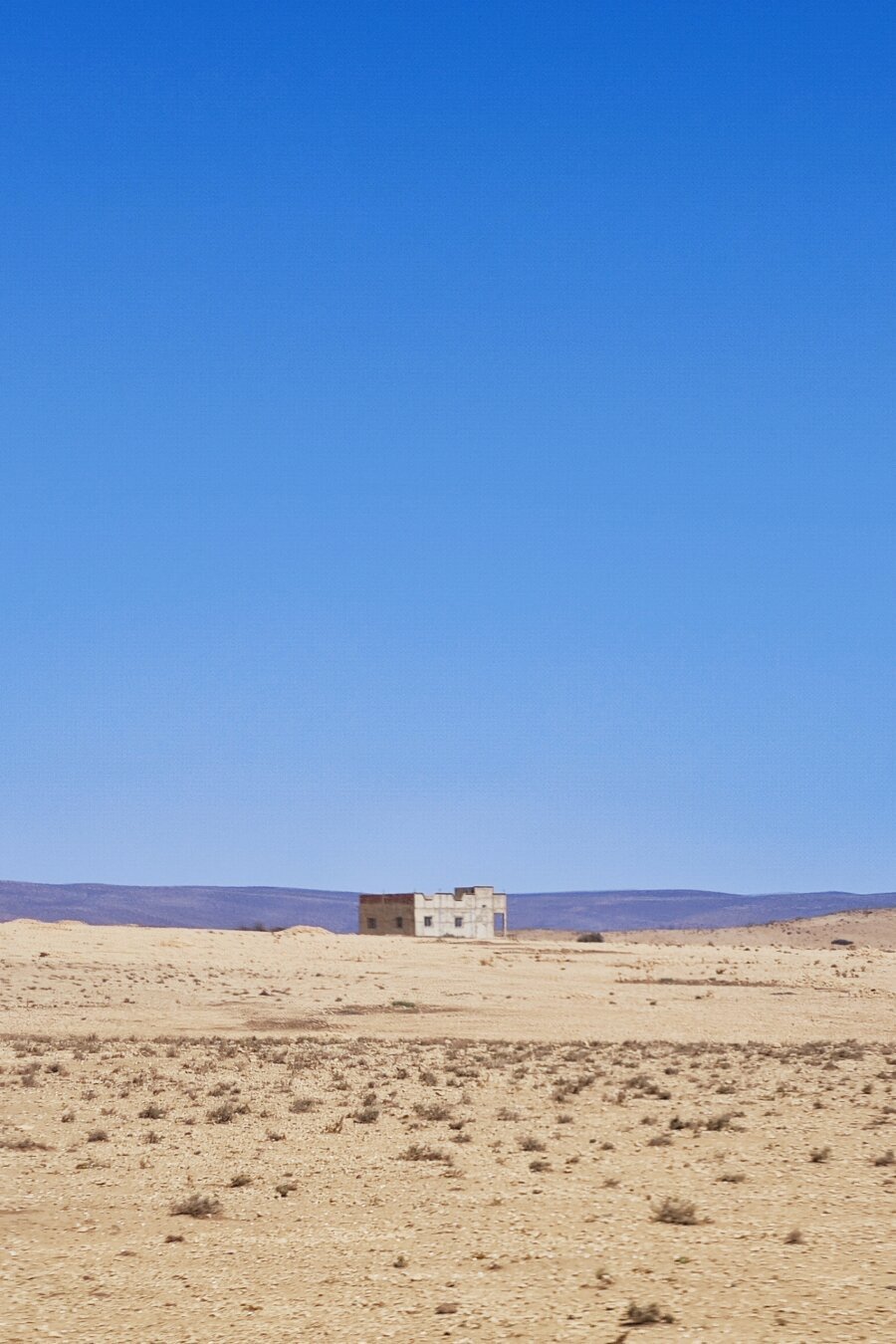 a low building in the middle of the steppe