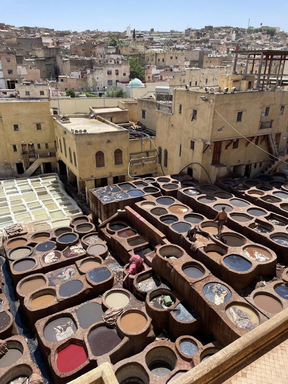 a tannery in the Medina in Fez. the white barrels at the top contain ammonia, the clay ones below - colored paints. you can see people working