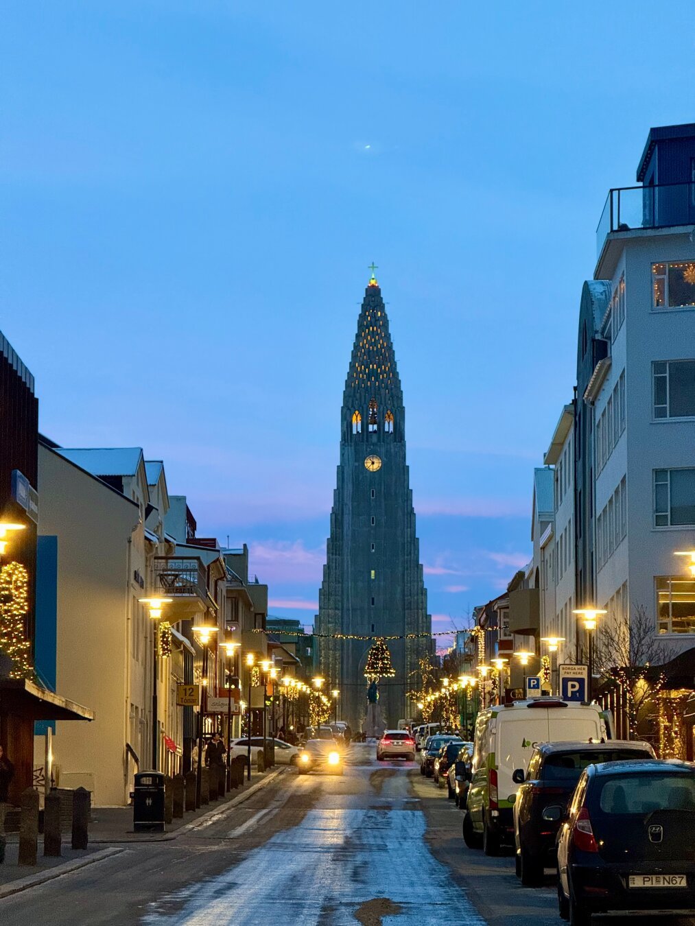 Hallgrímskirkja is in the distance with a city street and lights