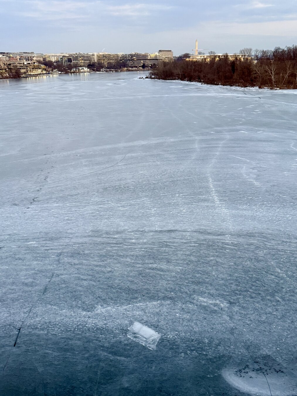 The frozen sheet of ice on the Potomac river as seen from the Key Bridge