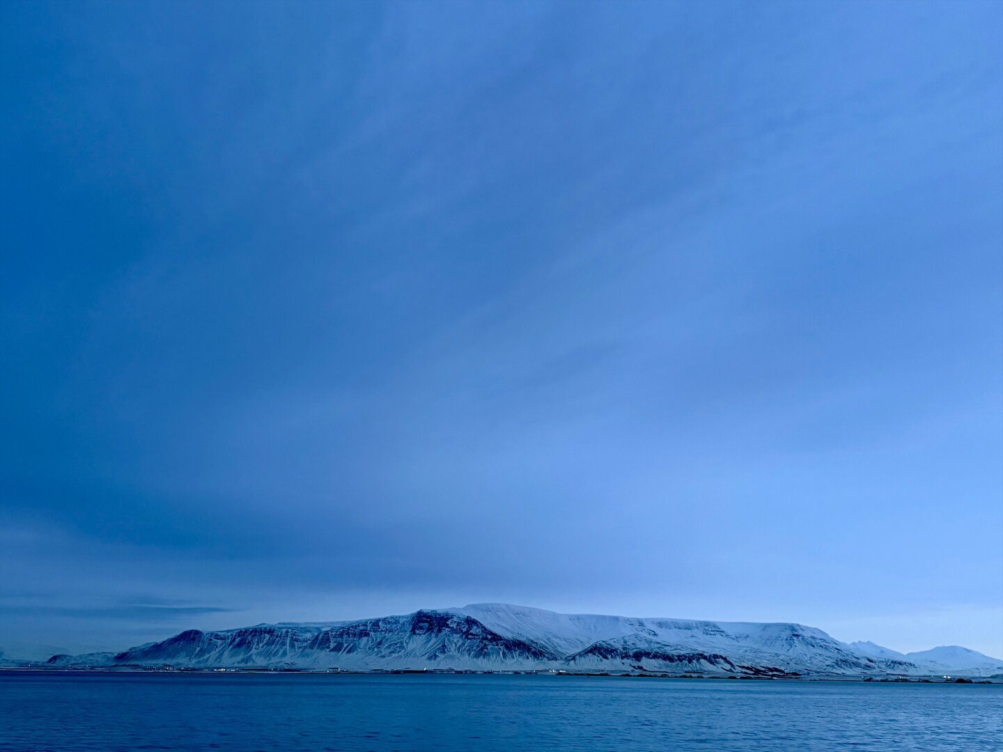 Mt. Esja under a cloudy blue sky