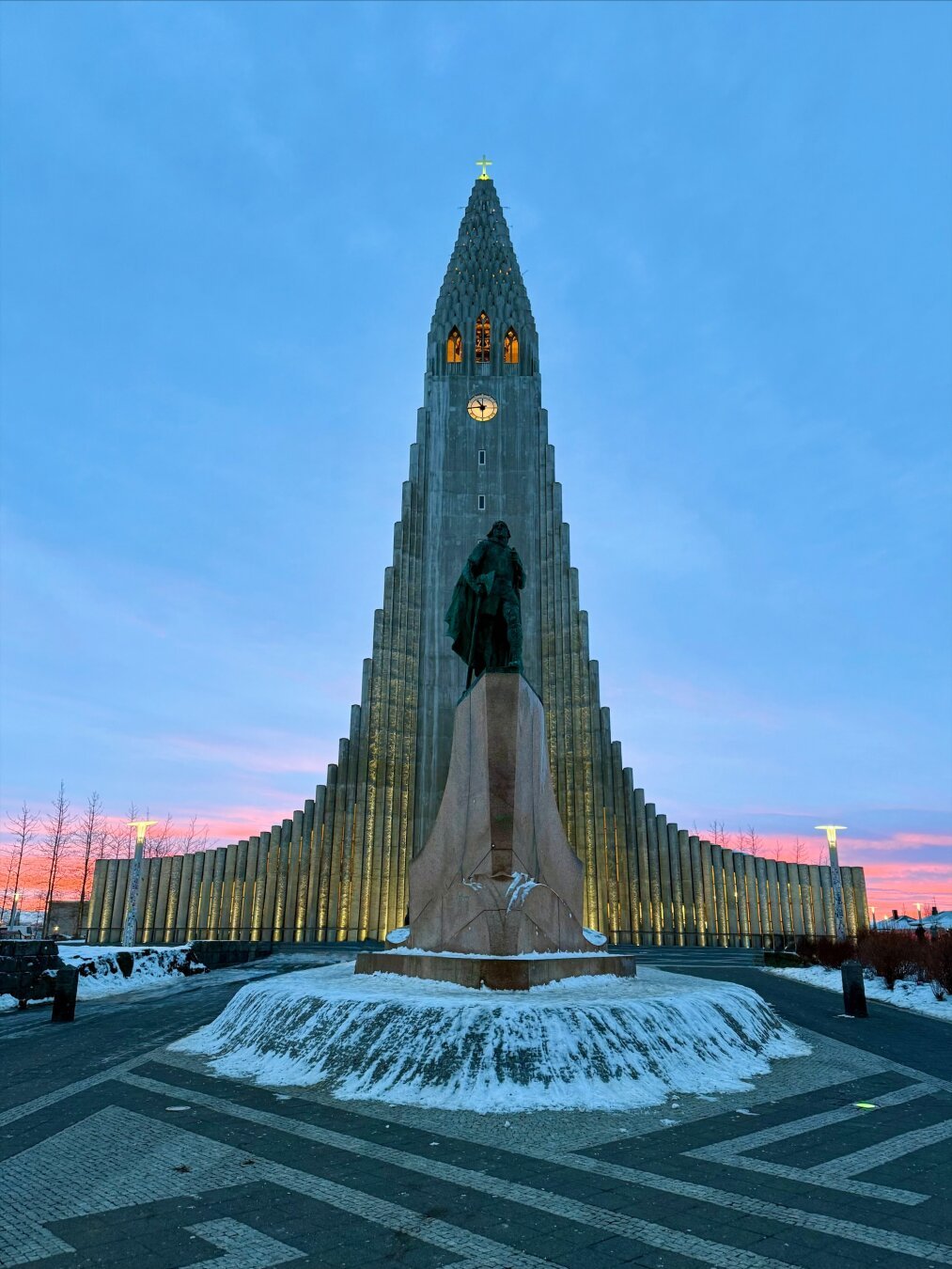 Hallgrímskirkja church with a very pink sunrise behind it