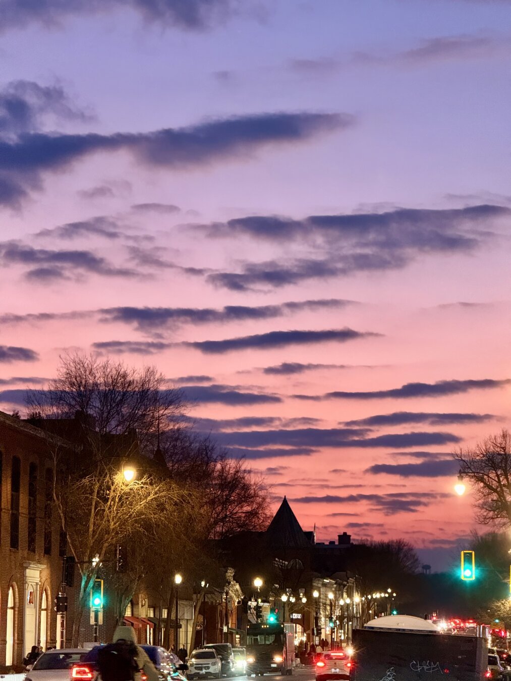 A purple to red sky with a city streetscape in Georgetown
