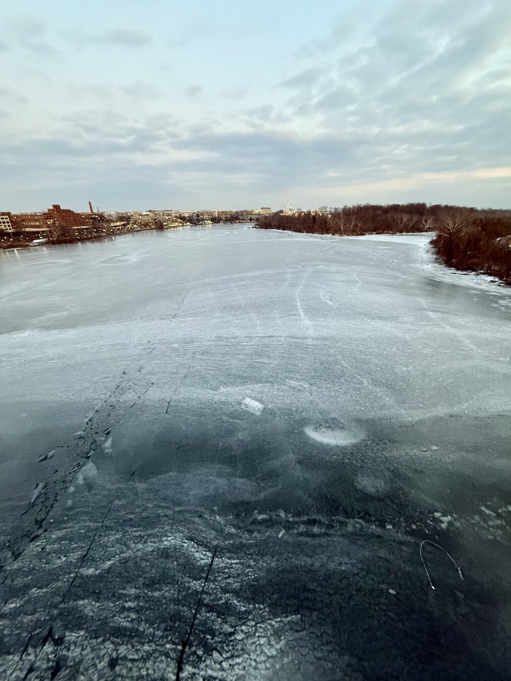 The frozen sheet of ice on the Potomac river as seen from the Key Bridge (wider shot)