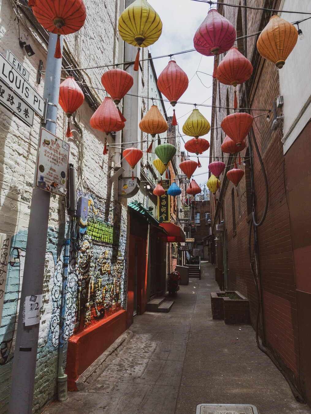 Looking down an alleyway in Chinatown with Chinese lanterns hanging on wires above