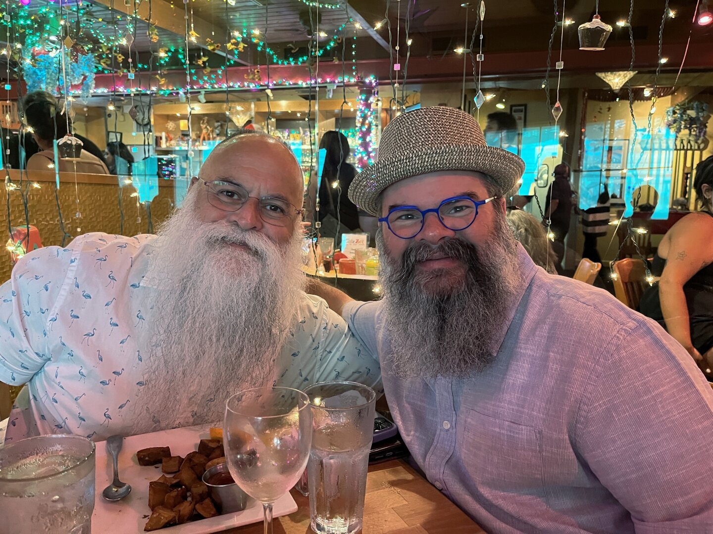 Jack and Mike sitting at a table at the restaurant Chez Zee having Sunday brunch with friends.