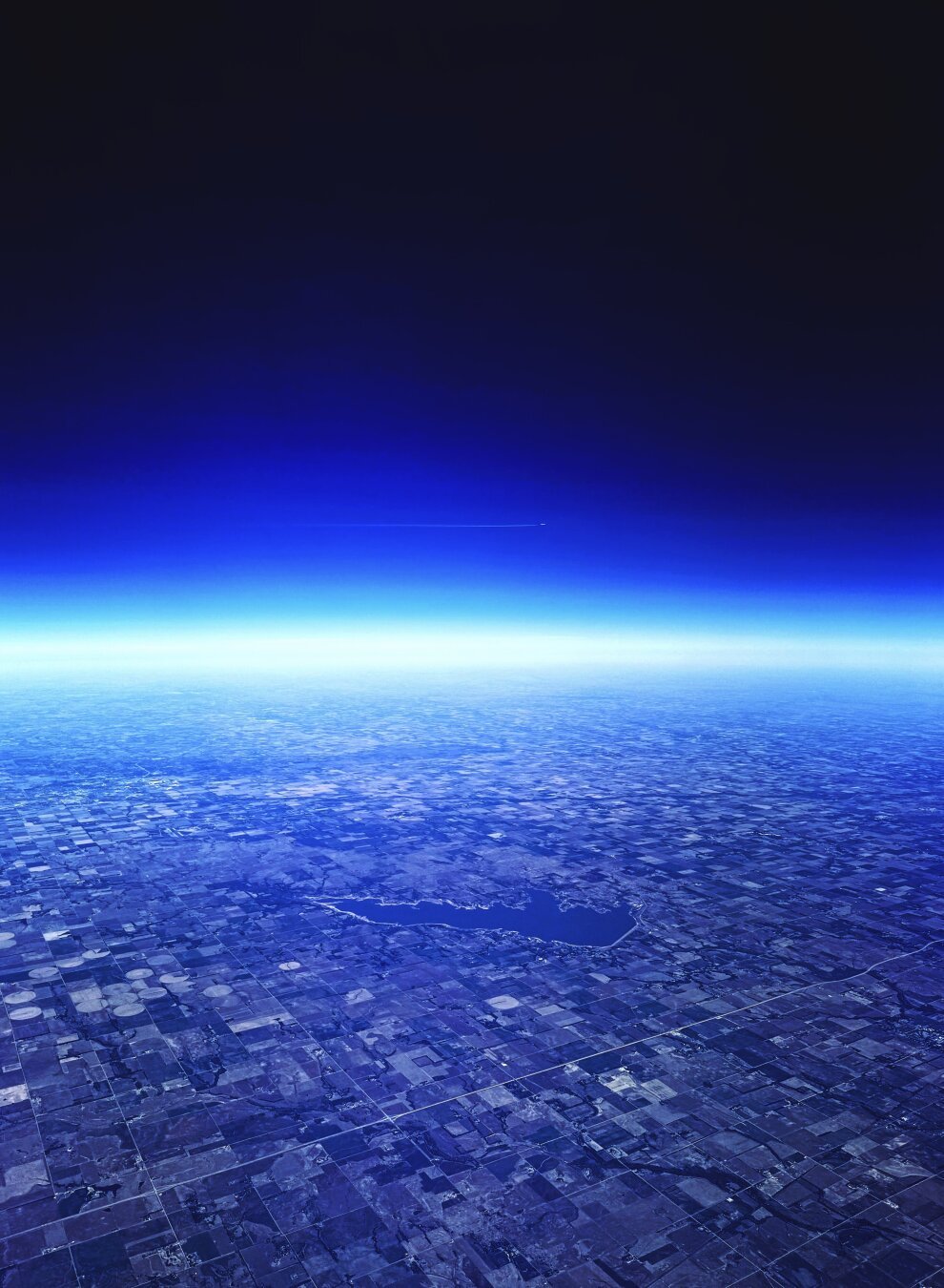 The flat state of Kansas, as viewed from a plane. Various high contrast photo filters applied.