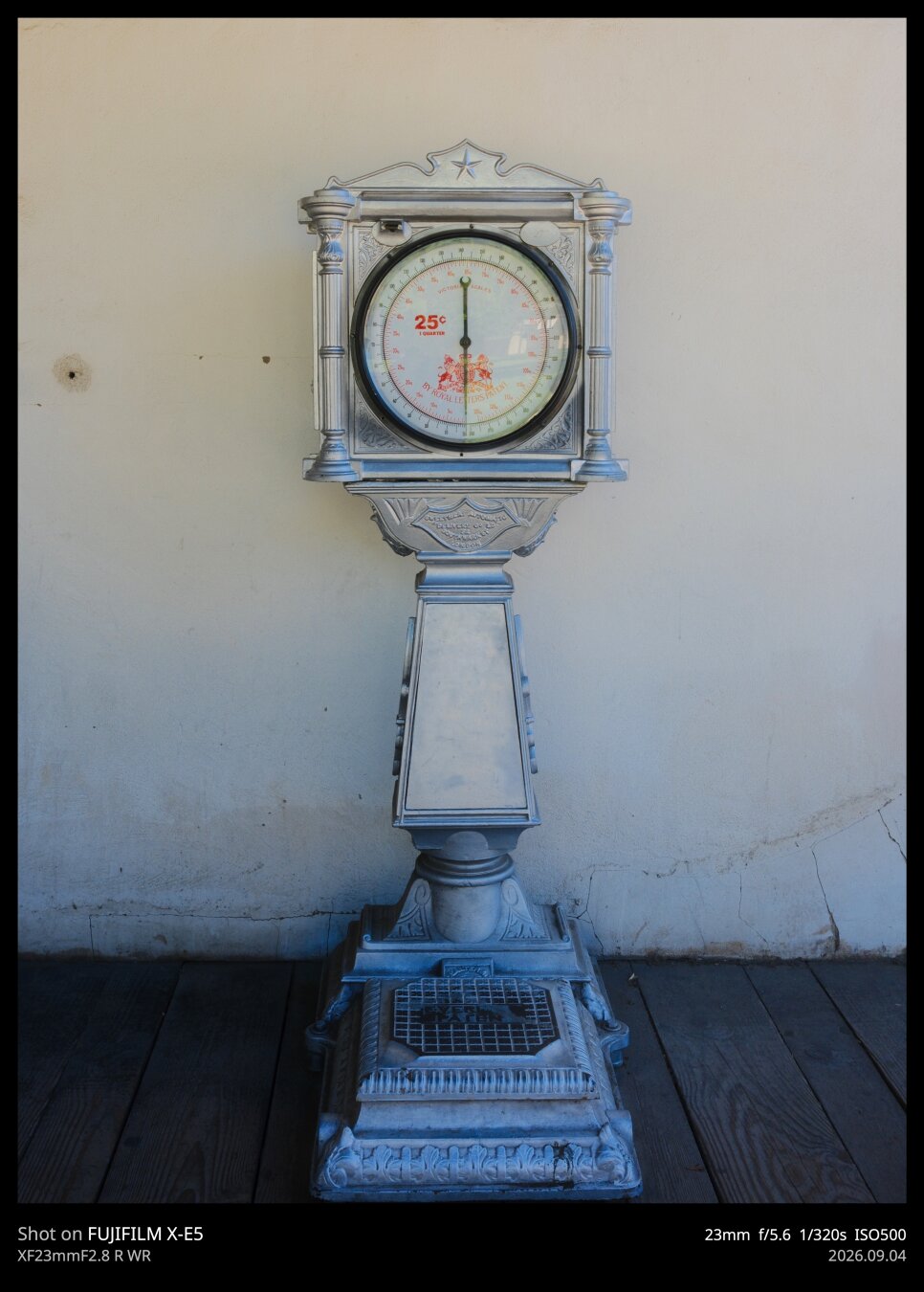 A large scale from the 1800s. Its silver, relatively ornate, features a circular face for reading weight.
