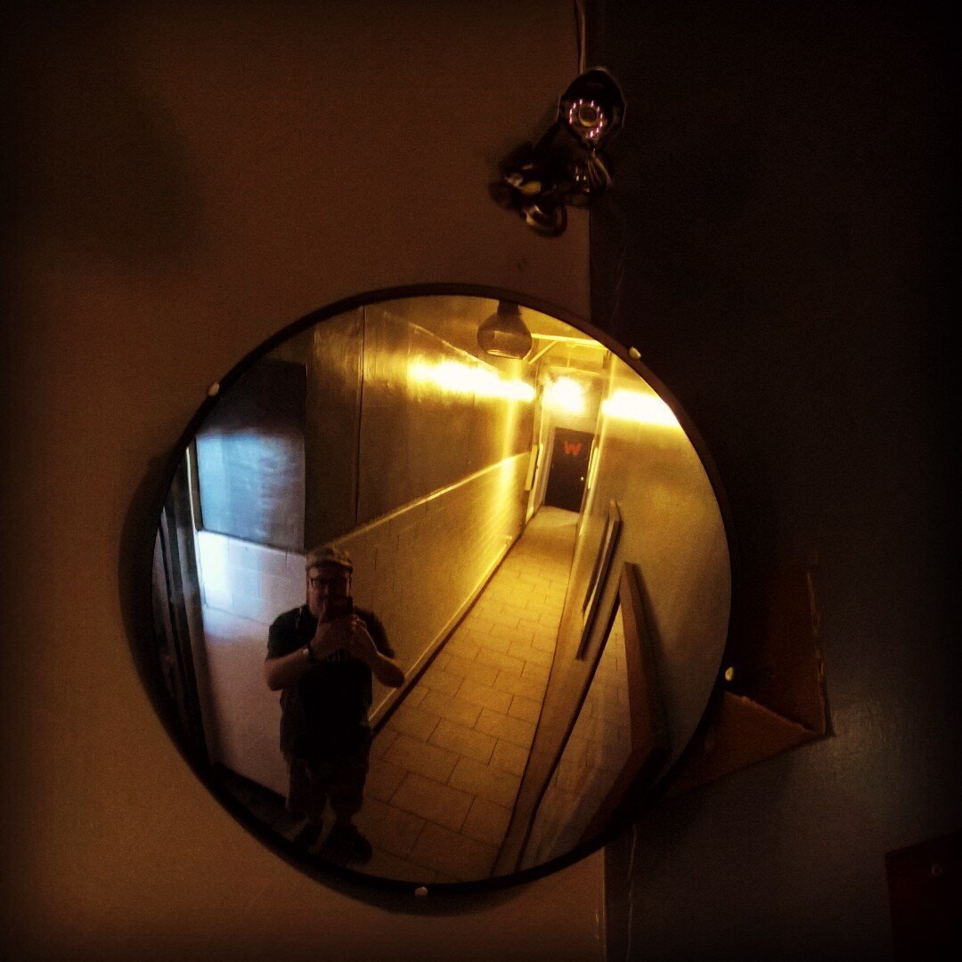 View down a hallway through a mirror