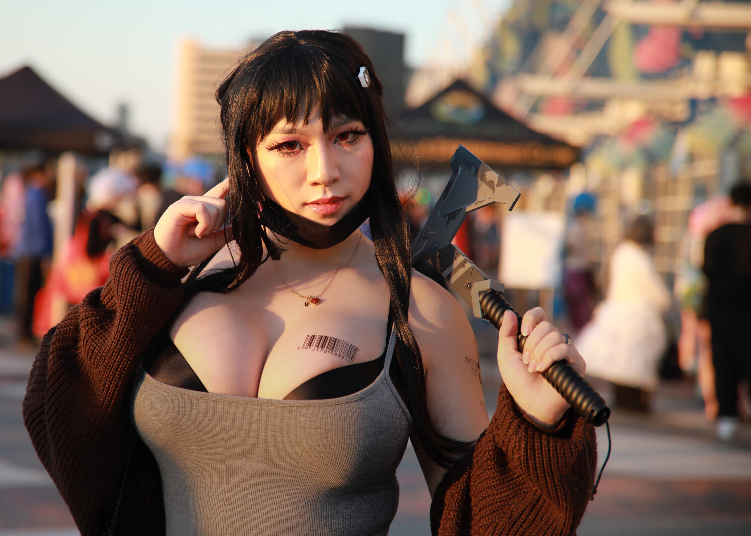 Young woman facing camera with gold sunlight coming from the left side of the frame.  She is wearing cosplay of D from Nikke Goddess of Victory.  There is ample cleavage as she is wearing a low cut top with black bra underneath.