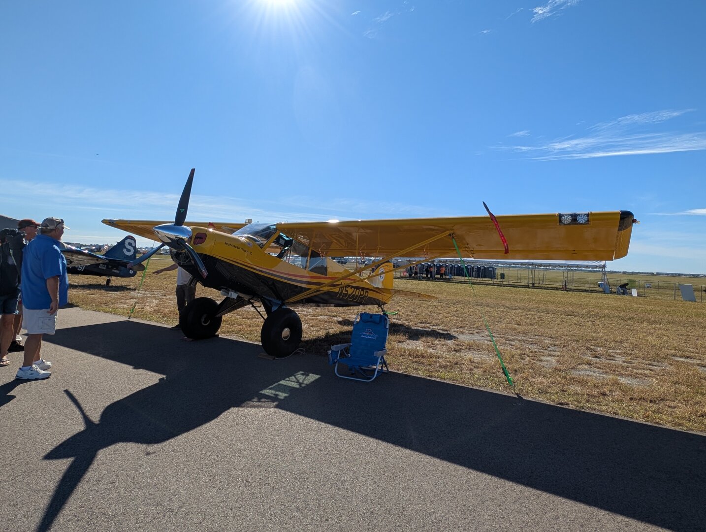 An Aviat Husky airplane. It's primarily yellow and black on the bottom.