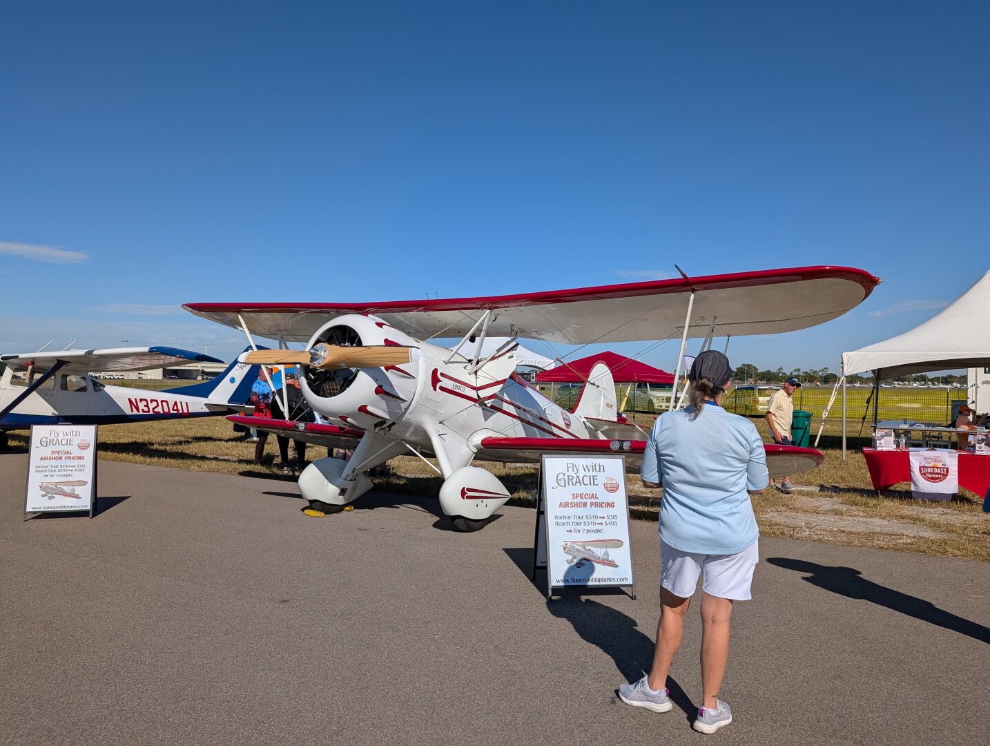 A red and white Waco YMF-5C biplane.  The plane is named Gracie and used for aerial sightseeing tours.