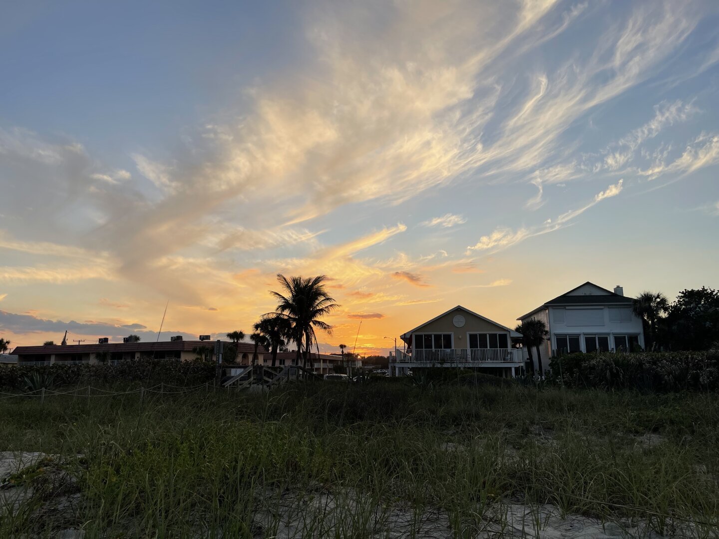Coastal buildings in front of a sunset sky