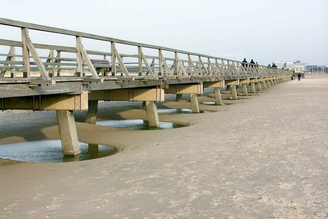 Wooden and concrete footpath on a beach.