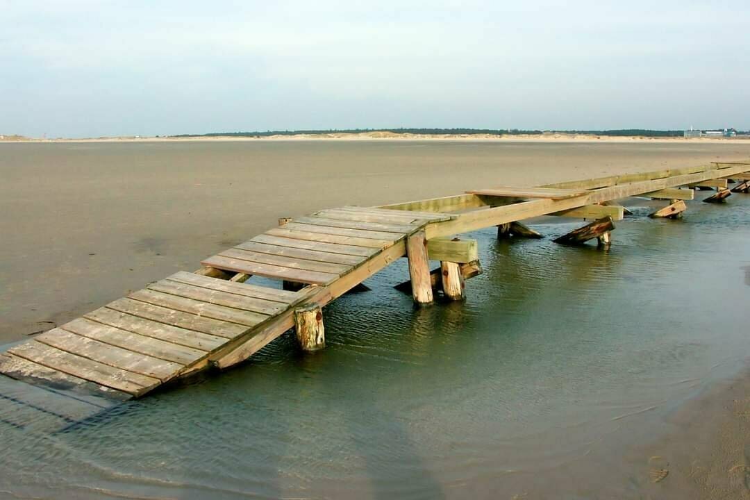 Old footpath on the beach with damage.