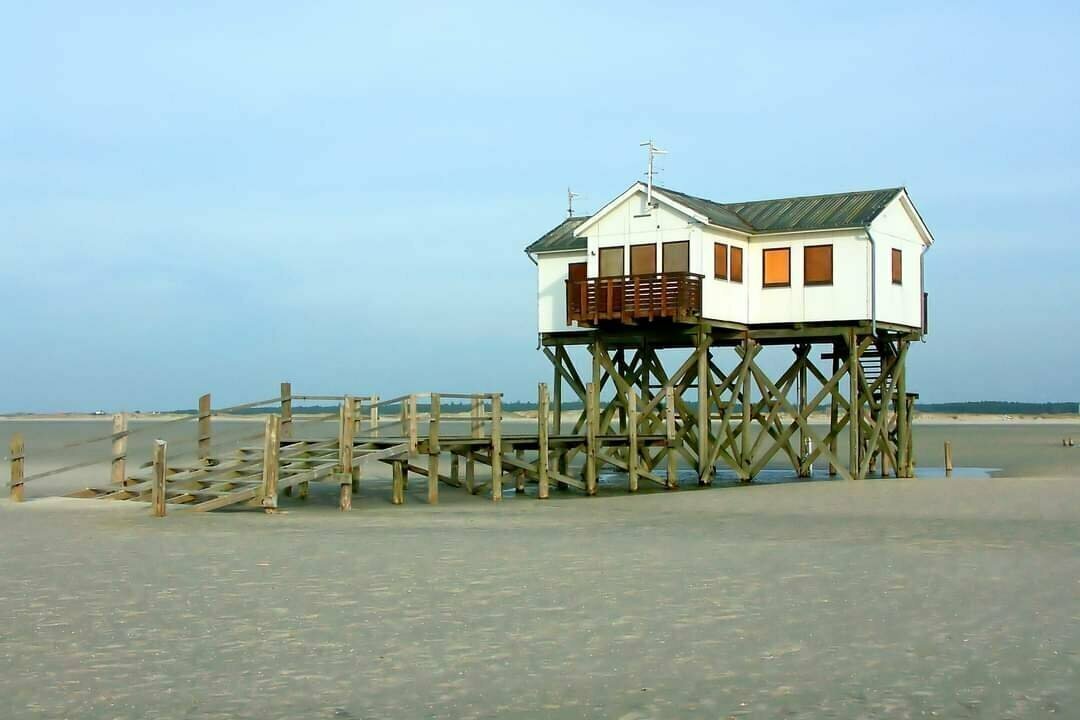 Buildings on wooden stilts on the beach.