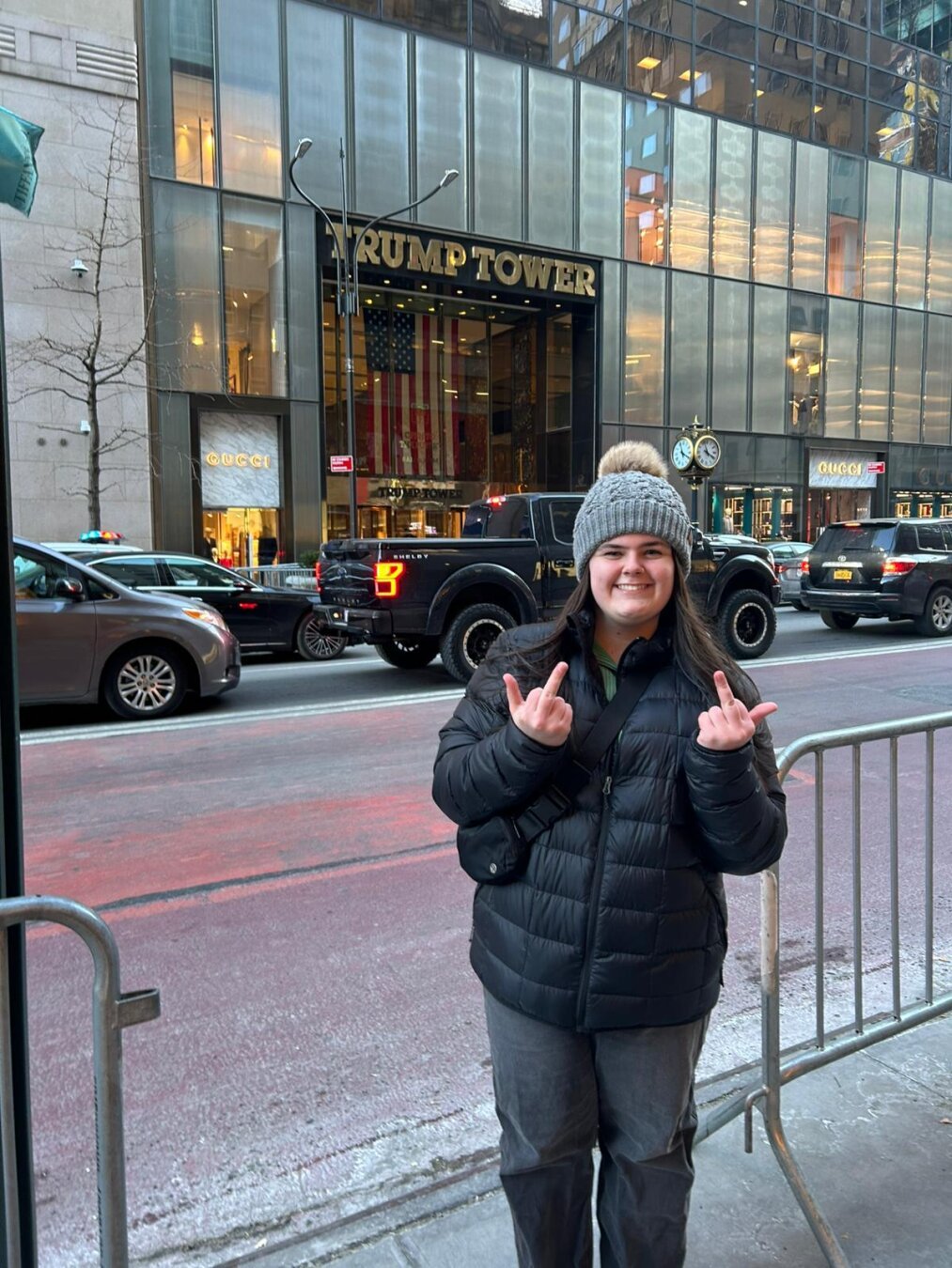 My daughter flipping off Trump Tower with a huge smile on her face.