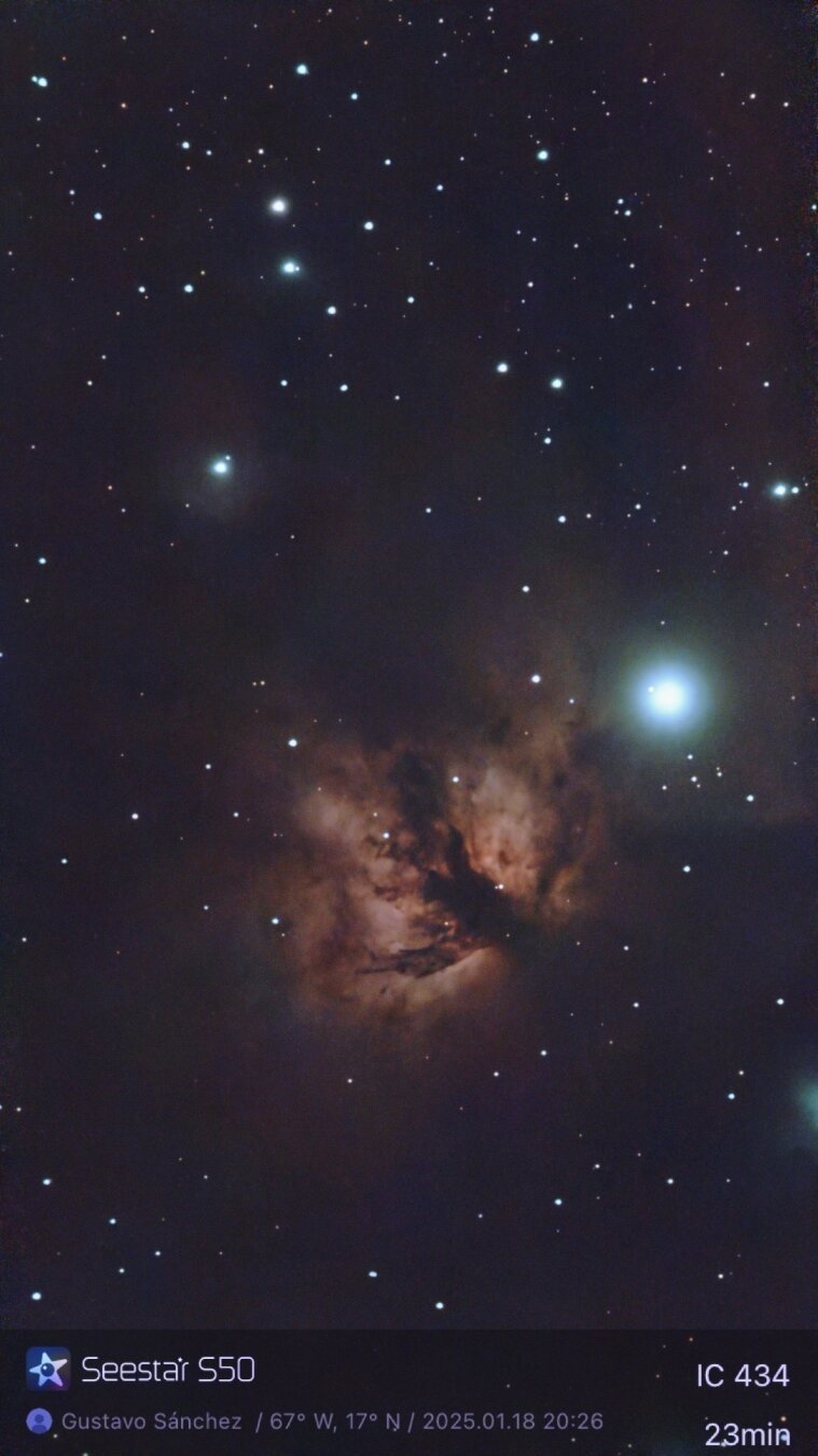 Image of a nebula that looks like a flame surrounded by dark space.