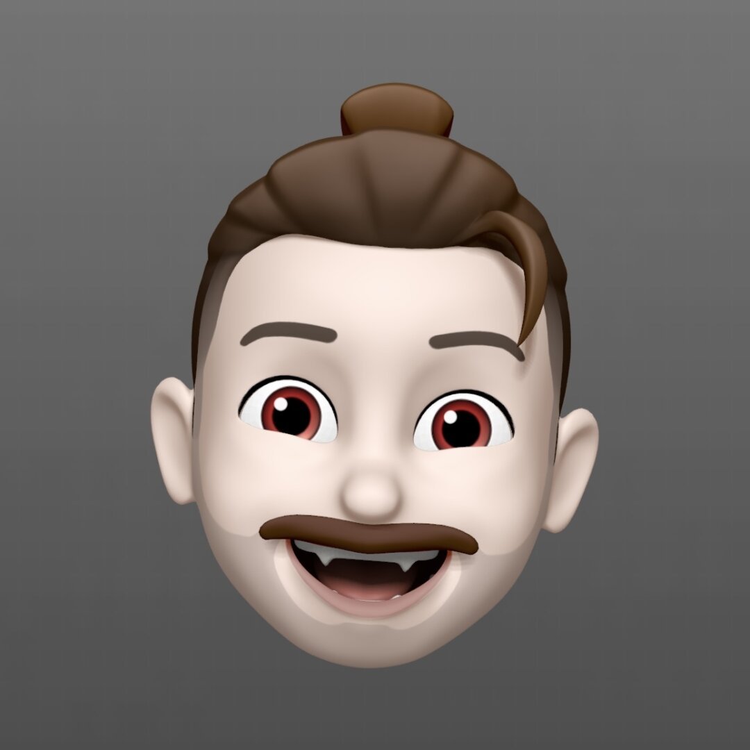 Memoji with pale skin, red eyes, and fangs.